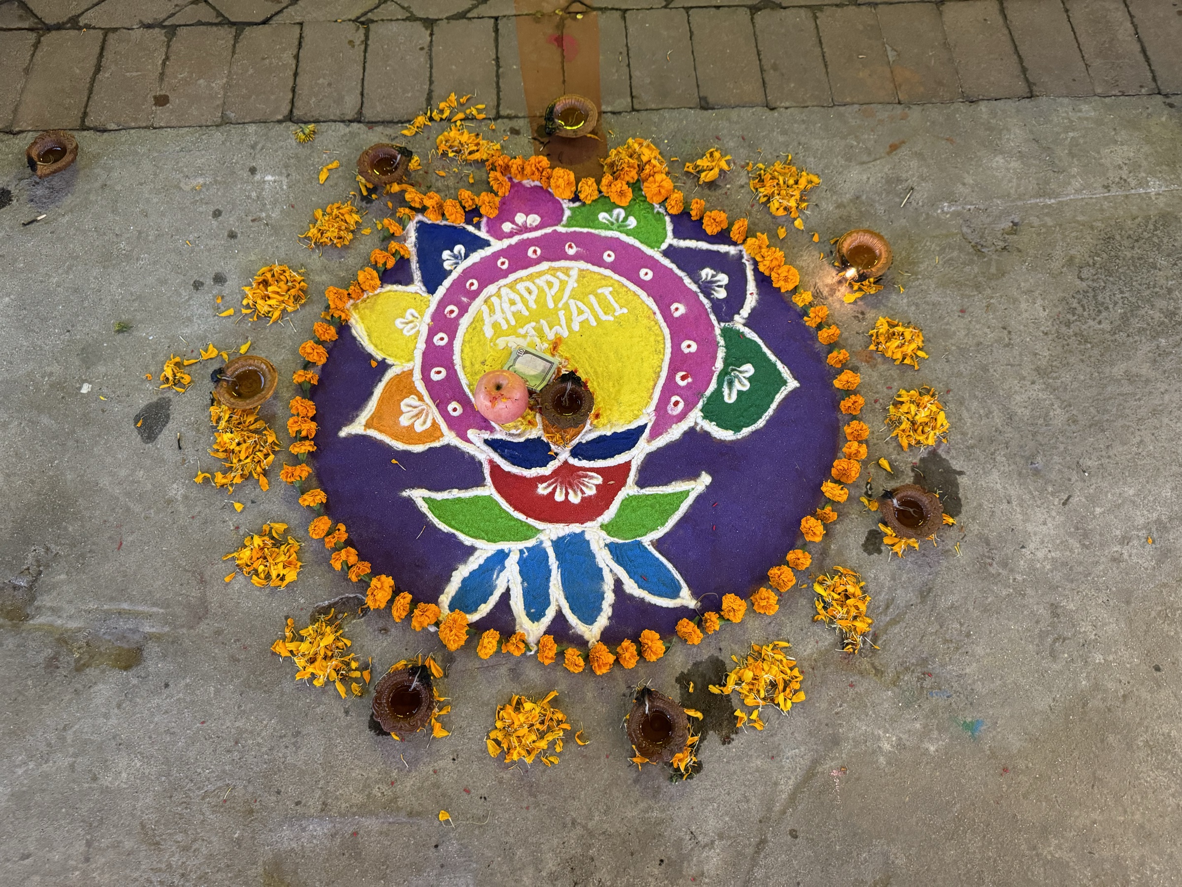 A sun and moon worked in coloured powder